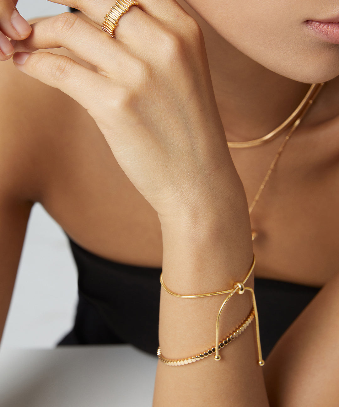 Gold- und Silberarmband mit Schiebeverschluss am Handgelenk getragen